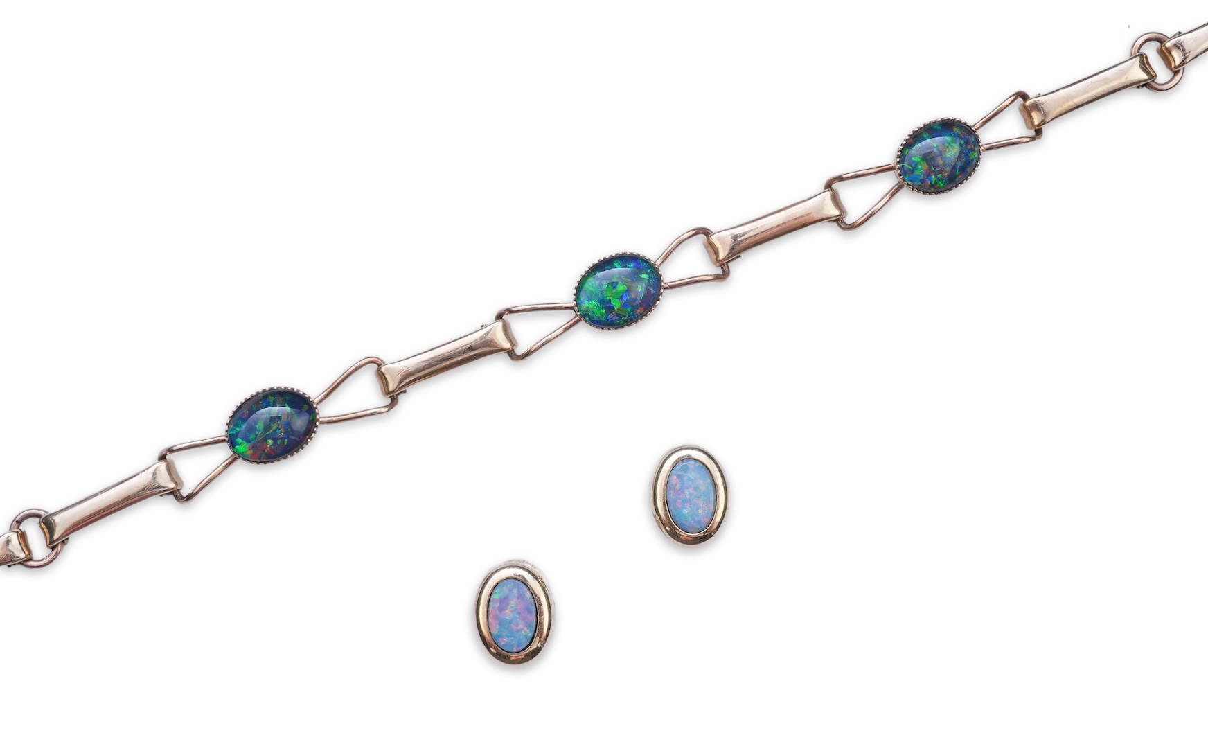 An opal triplet bracelet and pair of earrings, comprising: a gold bracelet set with opal triplets, length 18cm; and a pair of studs set with opal doublets, mounted in gold, length 0.8cm each, post fittings, stamped 585,